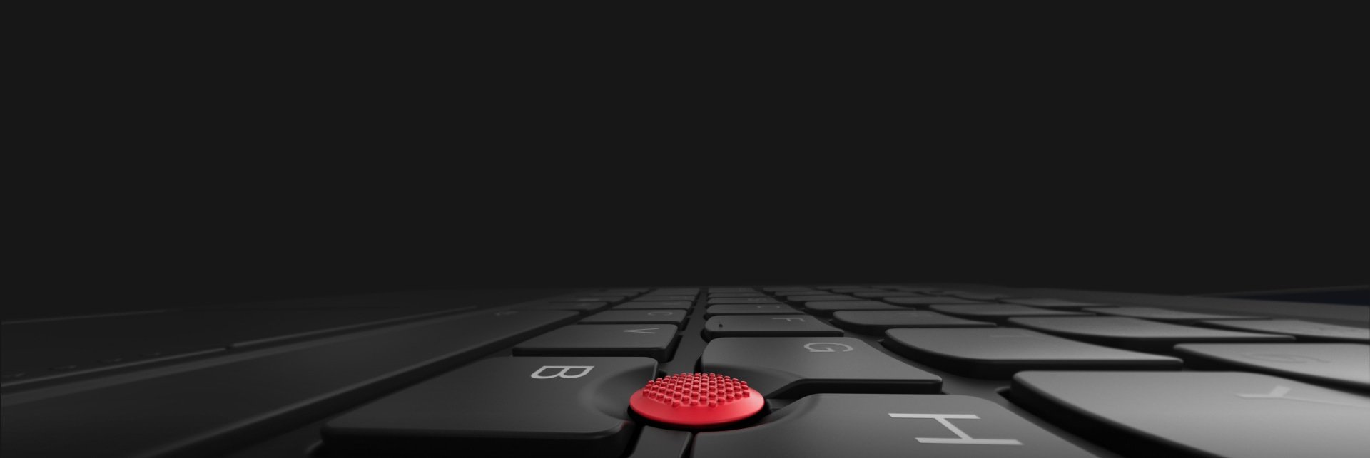 Close-up view of a Lenovo ThinkPad keyboard featuring the iconic red TrackPoint centered between the keys, with dramatic lighting and a sleek black design emphasizing ThinkPad's signature business laptop heritage.