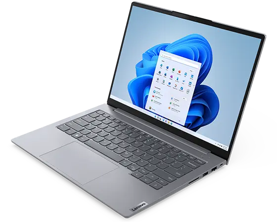 Vista superior del portátil Lenovo ThinkBook 14 de 6.ª generación mostrando la pantalla con el menú Inicio de Windows 11, el teclado y los puertos y las ranuras del lateral derecho.