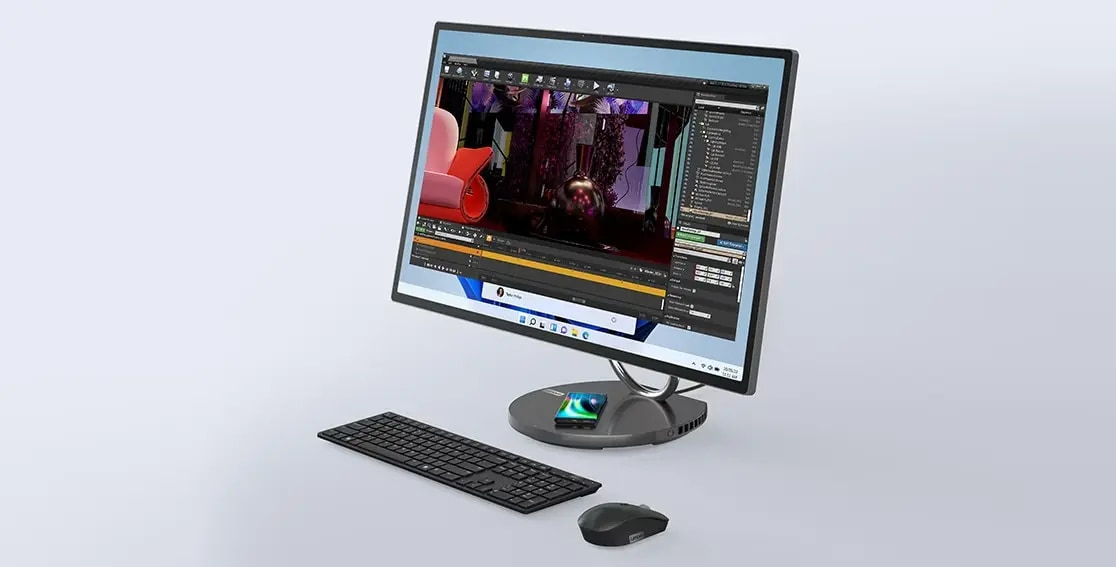 Yoga AIO 9i Gen 8 with video editing software on display. Mobile phone wirelessly charging on base, and optional mouse and keyboard in front
