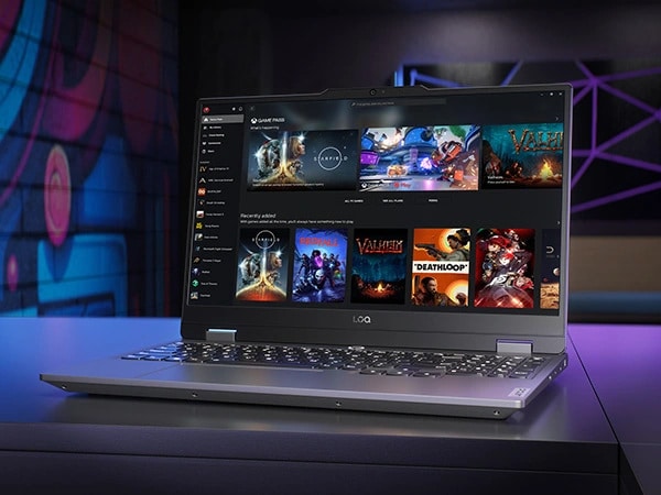Lenovo LOQ 15IAX9 gaming laptop on a table, with Xbox Game Pass menu on the display