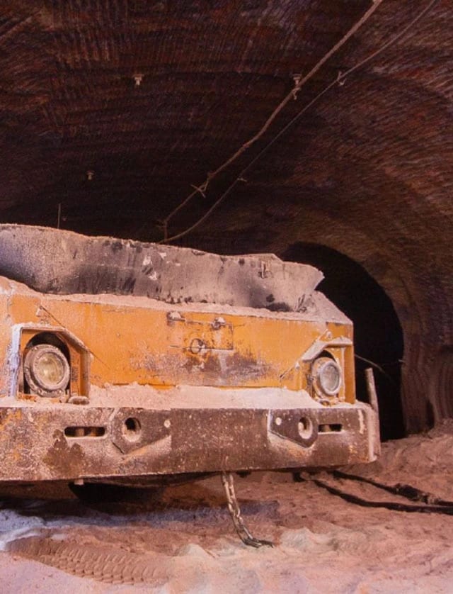 A rusted car sitting in a salt mine