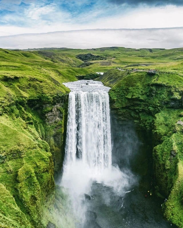 green landscape with a big waterfall