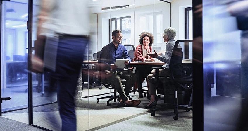 Three seated people talking