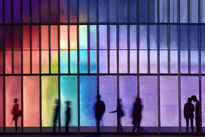 a group of shadowy people with a rainbow background