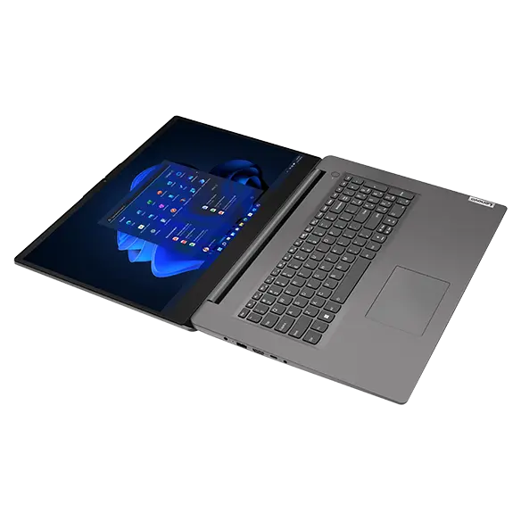 Aerial view of Lenovo V17 Gen 3 laptop at an angle, laid flat open, showing keyboard, display (with Windows 11 start-up menu), & left-side ports