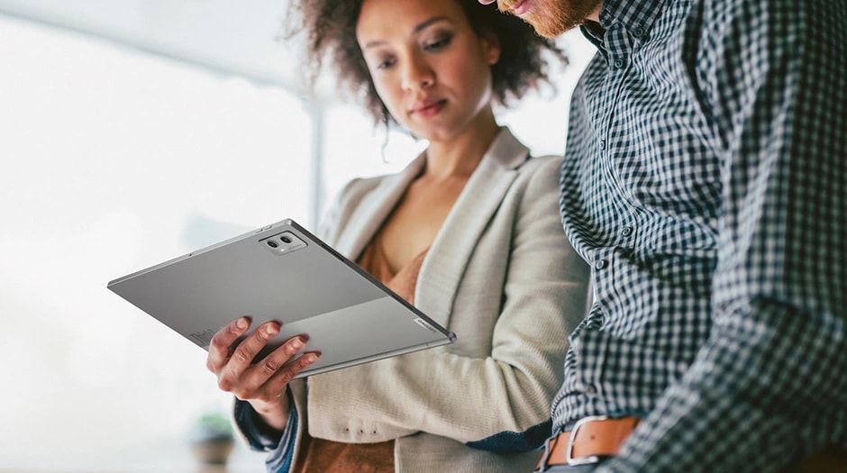 Two persons using Lenovo ThinkBook Plus Gen 5 Hybrid (14” Intel) Tablet for work discussion taking advantage of full Android experience while on the move.