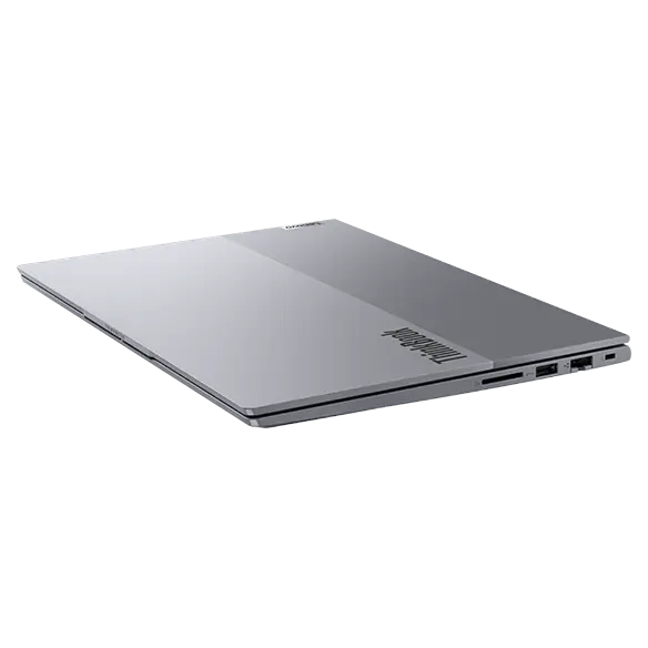 Right side, tilted view of Lenovo ThinkBook 14 Gen 7 (14 inch Intel) laptop with closed lid, focusing its top cover & four visible ports.