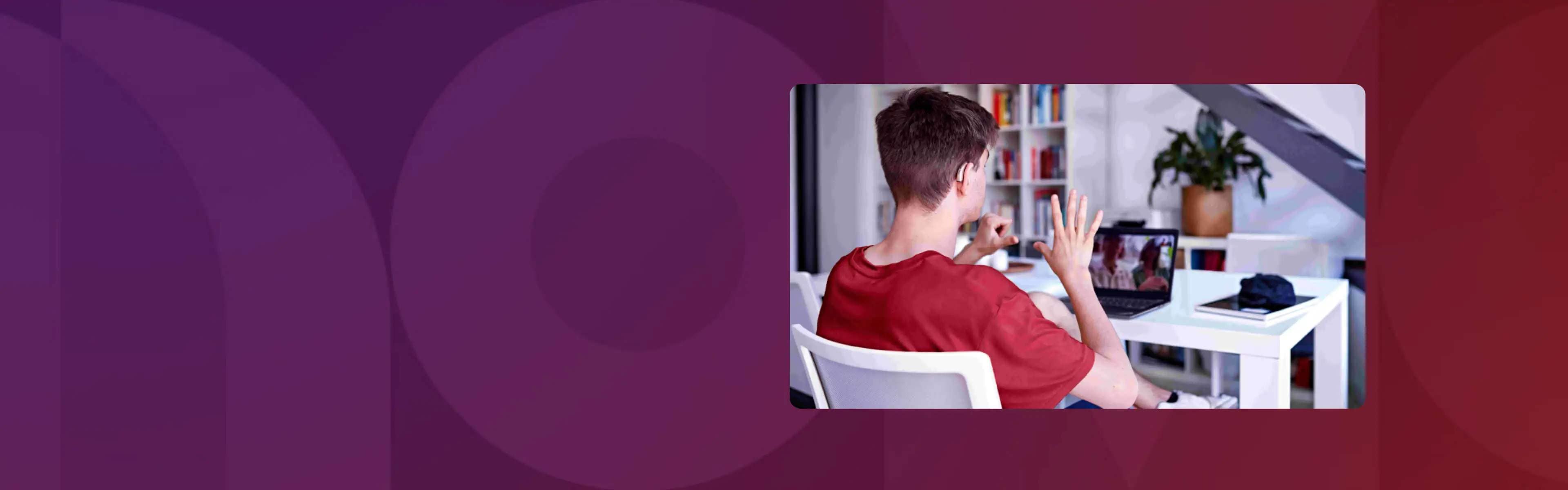 A man on a video conference call on his laptop using sign language to communicate