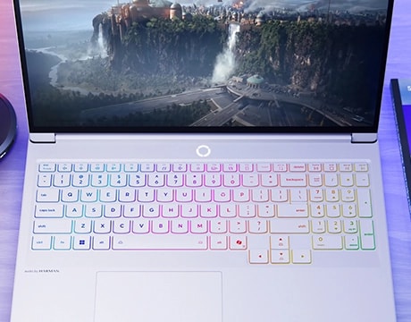 Top-down view of Legion 7i Gen 10 showing RGB keyboard and a digital cityscape on screen.