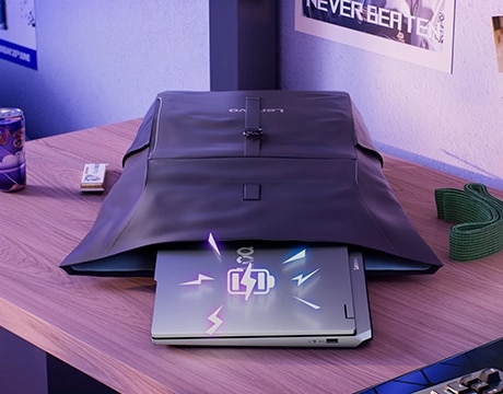 Lenovo LOQ Essential 15IRX11 gaming laptop protruding from an open backpack on a desk with a battery charge icon graphic superimposed on the lid.