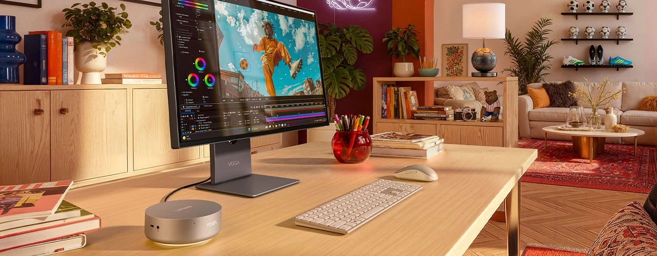 Lenovo Yoga Mini i Gen 11 (Intel) PC setup in a clean home office setup with a monitor and peripherals, focusing its smart connectivity features.
