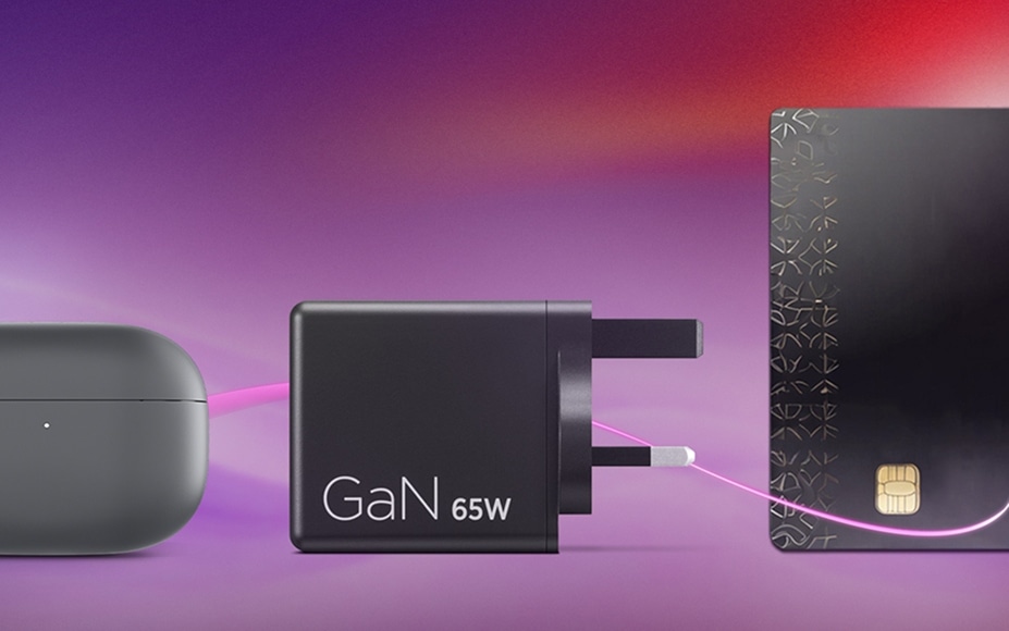 Compact 65W GaN charger, shown with earbud case and credit card for size, on a purple-pink gradient background.