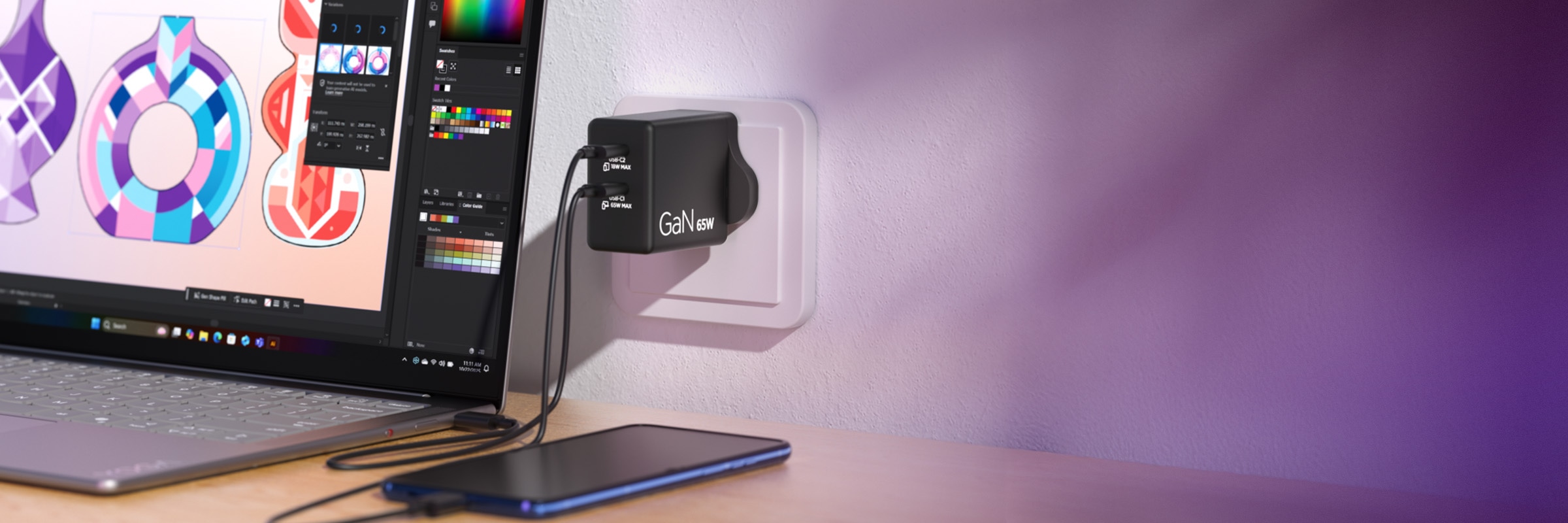 65W GaN wall charger with dual USB-C ports, powering a laptop running design software and a smartphone, on a desk with purple ambient lighting.