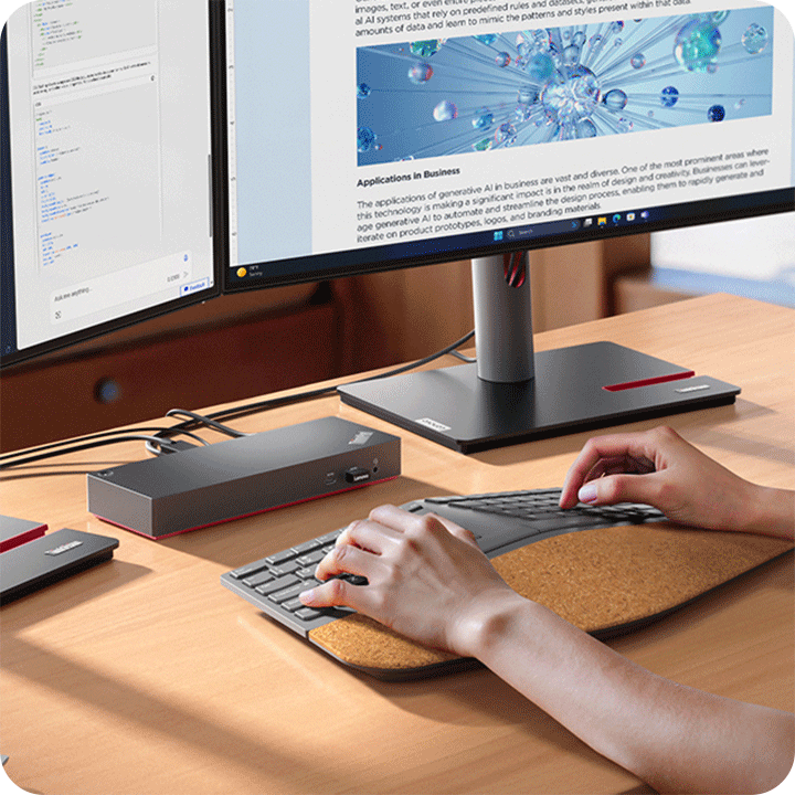 At home, a person is using the keyboard and the ThinkPad dock which connects two monitors.