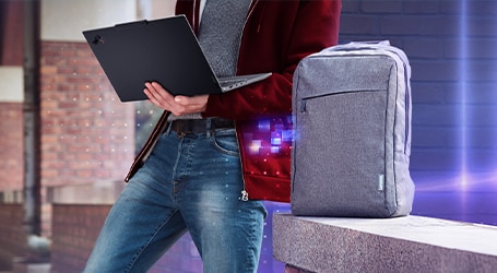 Lenovo casual backpack displayed next to a ThinkPad X1 Carbon laptop.