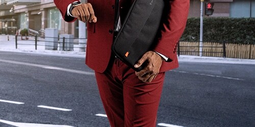Man with suit carrying an STM suitcase for laptops