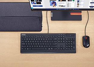 A Lenovo keyboard, mouse, monitor and urban sleeve are featured on a desk.