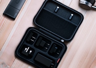 A Lenovo power adapter is featured on a desk.