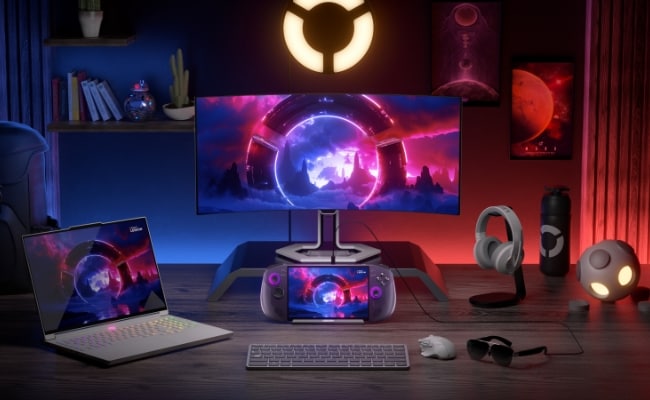Gaming setup featuring Lenovo Legion Go S Gen 1 (8") handheld connected to a monitor, laptop, and accessories.