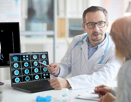 The doctor explains brain scans to a patient using the Lenovo ThinkPad P16s i Gen 5 (Intel) mobile workstation in a modern clinic.