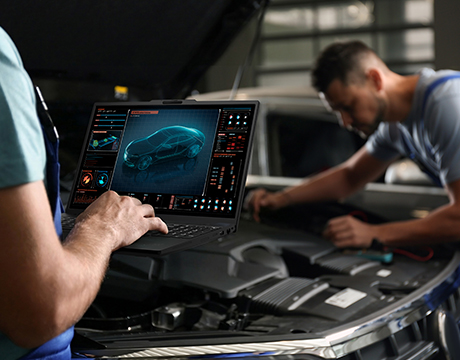 Mechanics diagnosing a car with advanced software on the Lenovo ThinkPad P16s i Gen 5 (Intel) mobile workstation in a repair shop.