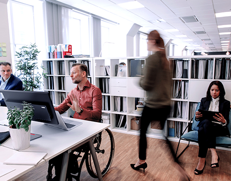 An office scene with diverse professionals working, emphasizing inclusivity with Lenovo ThinkPad P14s Gen 7 (14" AMD) laptop.