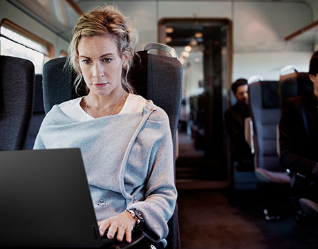 Individual using a Lenovo ThinkPad P14s Gen 7 (14" Intel) mobile workstation on a train, focused on work.