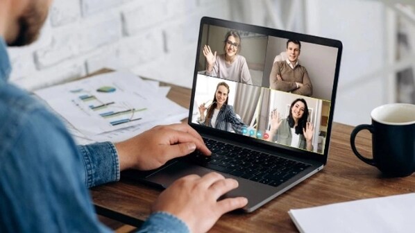 Remote employee videoconferencing on a laptop