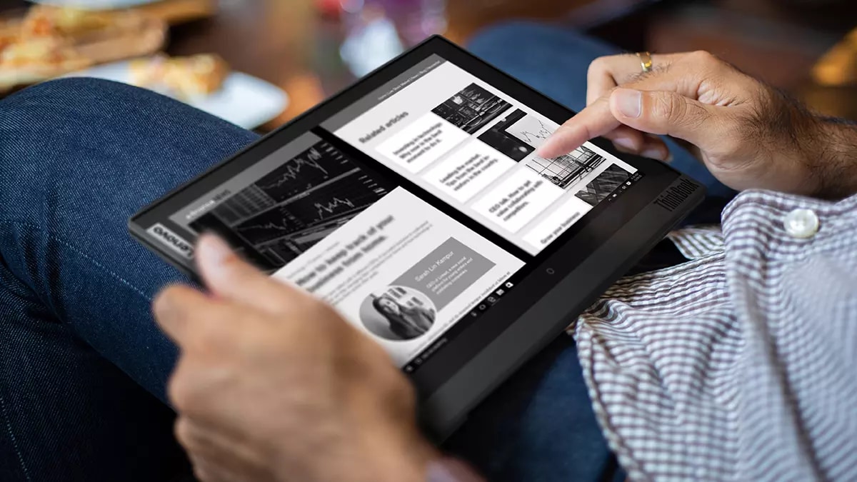 Someone reading an online articl on a Lenovo Thinkbook Plus Gen 2 in tablet mode.