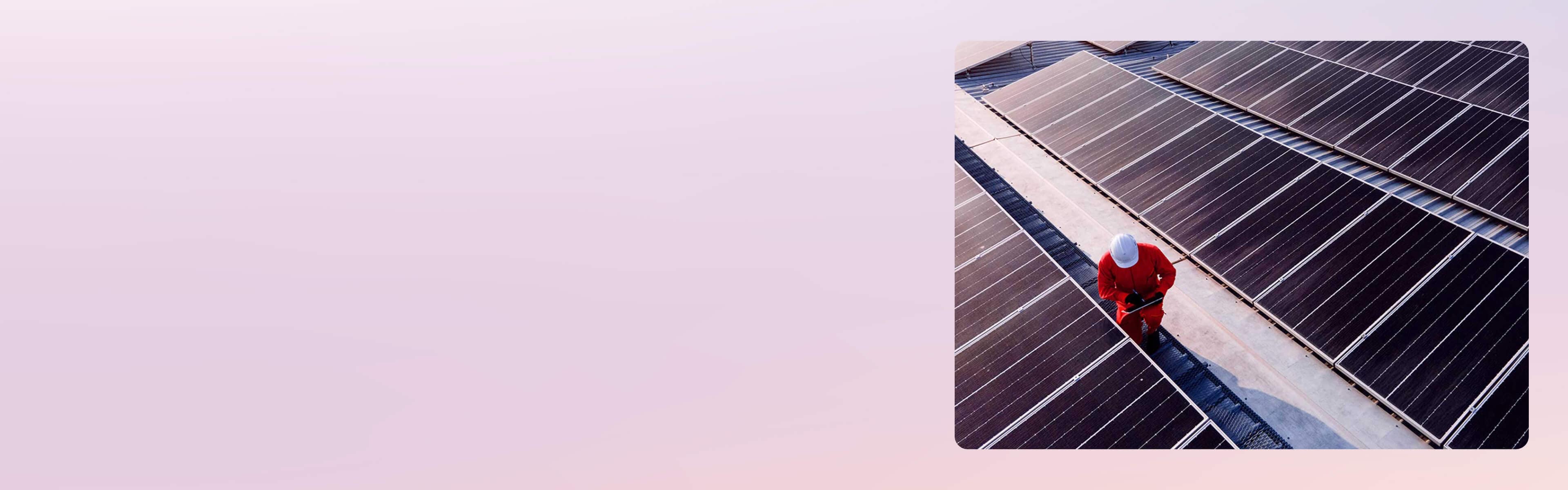 A person working in a solar panel field.
