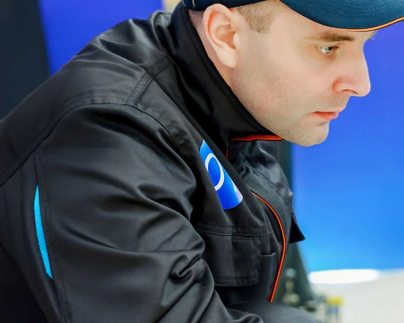 A Geely Auto employee working on a car.
