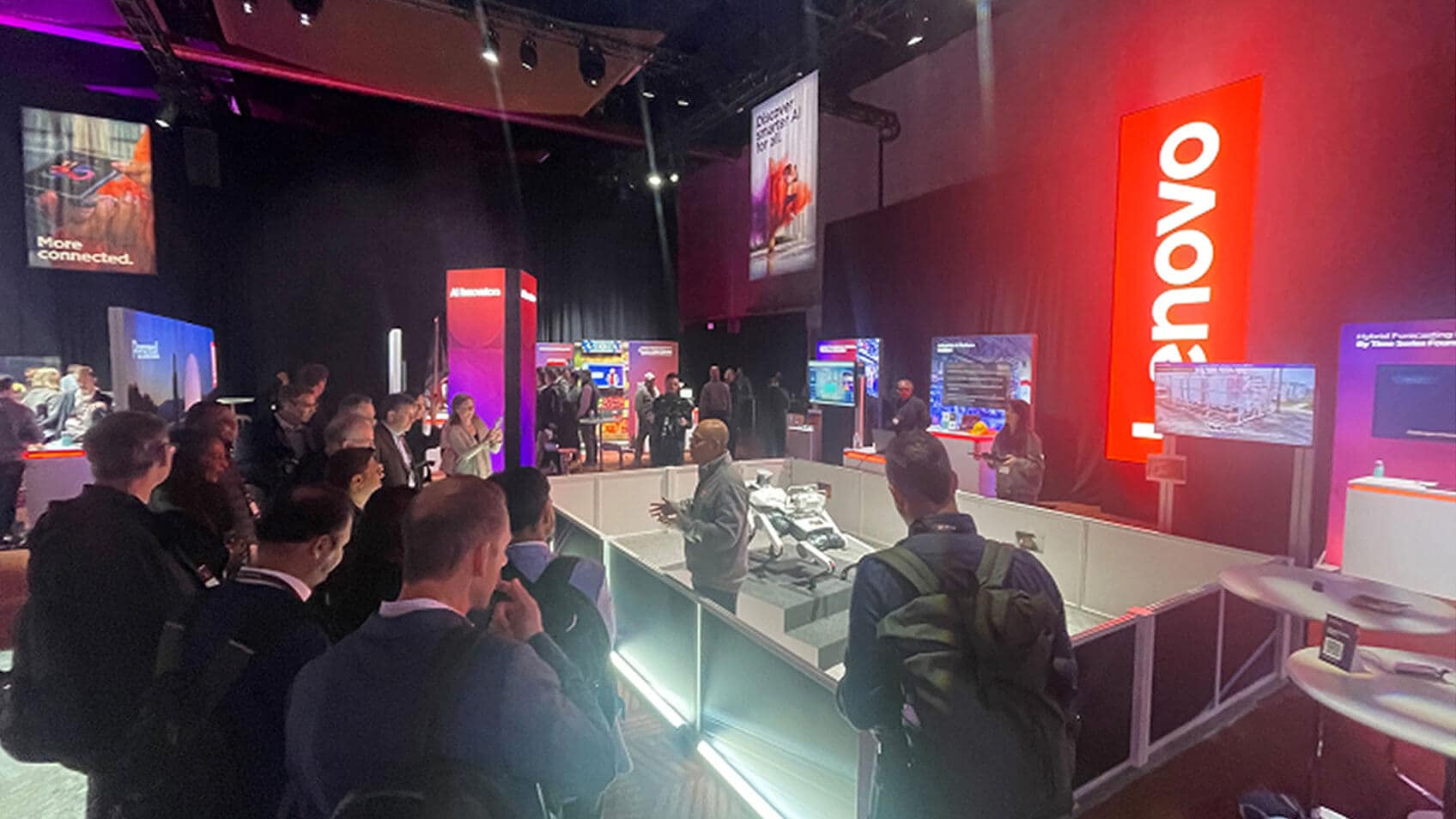 A Lenovo employee presenting a robot to onlookers.