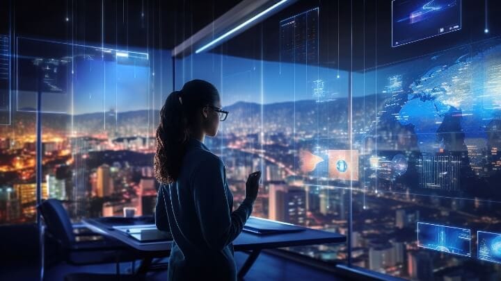 Image of a woman in a corporate office interacting with hi-tech displays.