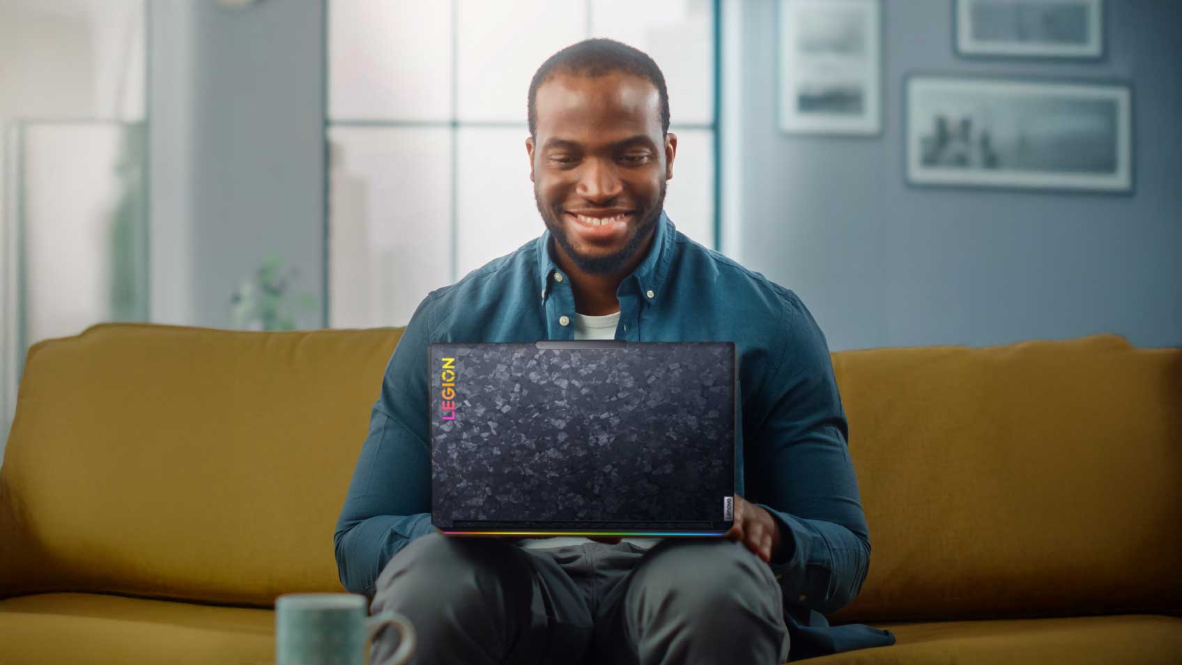 A man sitting on his couch and using a laptop