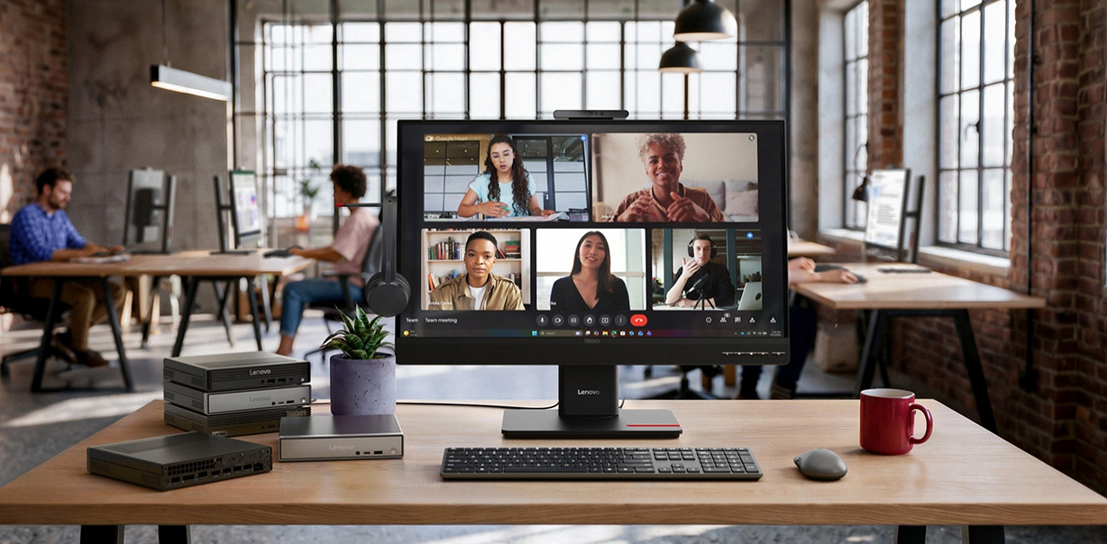 ThinkCentre TIO27 Gen6 Monitor displaying a team video conference in a modern office workspace.