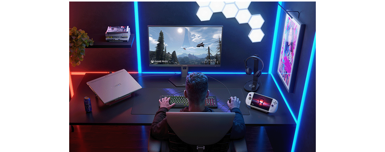 A man sitting at a desk, focused on the monitor Legion-27qd-10 while playing a video game. מסך מחשב גיימינג Legion 27QD-10 מבית Lenovo