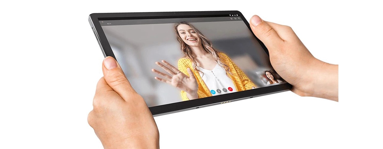 Two hands holding Lenovo Tab P11 Plus tablet with two video call participants on the display