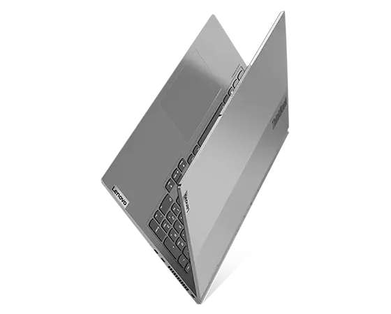 Aerial view of ThinkBook 16p Gen 3 (16" AMD) laptop, balanced on its side, opened 25 degrees in a V-shape, showing part of keyboard and top cover