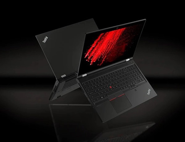 Two back-to-back Black Lenovo ThinkPad P15 Gen 2 laptops floating midair, open 90 degrees, showing keyboard, display, and partial back-side with burst of red color on screen.