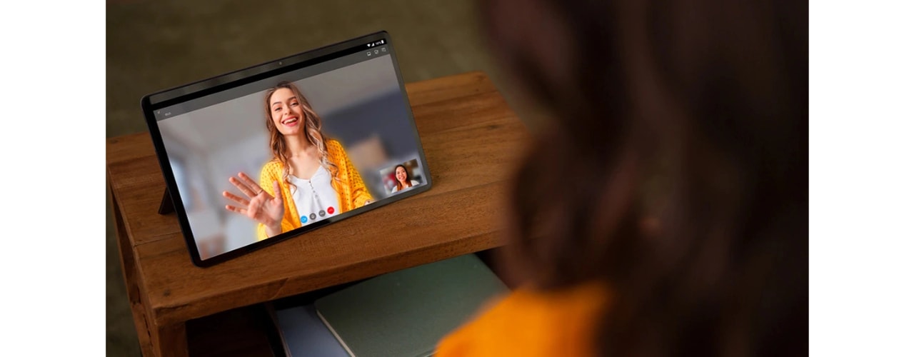  front view of two hands holding Lenovo Tab P11 tablet horizontally during video call