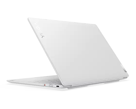 Rear-facing Yoga Slim 7i Carbon laptop, at an angle., opened 45 degrees, showing rear cover, part of cover, and right-side ports