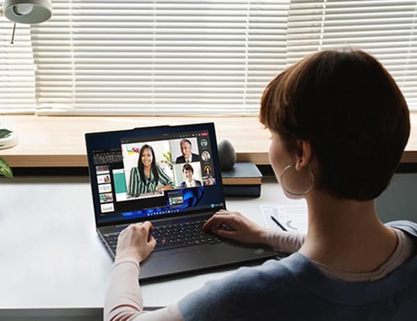 Person at a table or desk, using a Lenovo ThinkPad E16 (16″ Intel) laptop for a videoconference