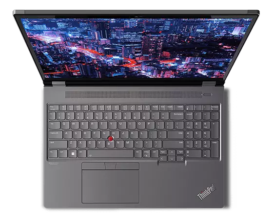 Aerial view of Lenovo ThinkPad P16 Gen 2 (16″ Intel) laptop, opened, showing display with skyscrapers at night, plus keyboard